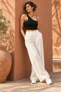 Asymmetric Strap Rib Crop Top in Jet Black – leaning on a terracotta wall