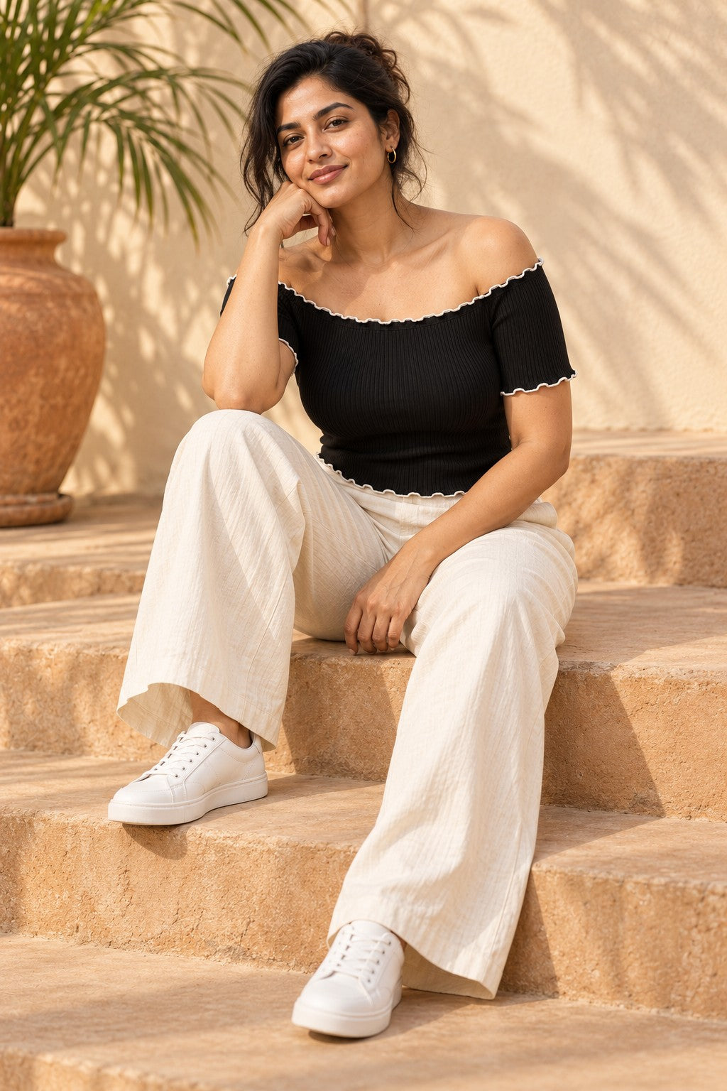 Off Shoulder Lettuce Edge Rib Top in Jet Black – seated on steps