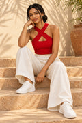 Cross Neck Rib Crop Top in Fiery Red – seated on steps