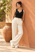 Notch Neck Rib Crop Top in Jet Black – leaning on a terracotta wall