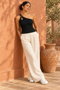 Ring Strap One Shoulder Rib Top in Jet Black – leaning on a terracotta wall