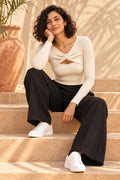 Twist Front Keyhole Rib Top in Coconut Milk – seated on steps